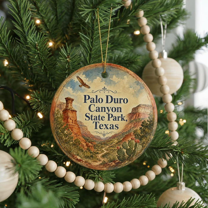 A round ornament hanging on a Christmas tree, featuring a scenic image of the Palo Duro Canyon State Park in Texas.