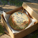 A decorative ornament in a box, featuring a scenic image of the Palo Duro Canyon State Park in Texas.