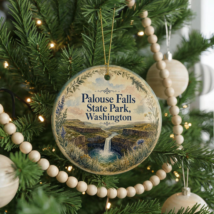 A Christmas tree decorated with ornaments, including a circular ornament with a scenic image of Palouse Falls State Park in Washington.