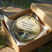 A decorative ornament in a brown box, featuring a scenic image of Palouse Falls State Park in Washington.