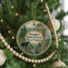 A Christmas tree decorated with ornaments, including a round ornament with a scenic image of the Panther State Forest in West Virginia.