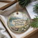 A decorative ornament with a scenic landscape of a lake, mountains, and pine trees, hanging from a string.