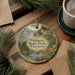 A decorative ornament featuring a scenic image of Pattison State Park, Wisconsin, hanging on a wooden surface.