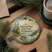 A decorative ornament with a scenic landscape of Penrose Point State Park, Washington, featuring pine trees, a lake, and mountains.