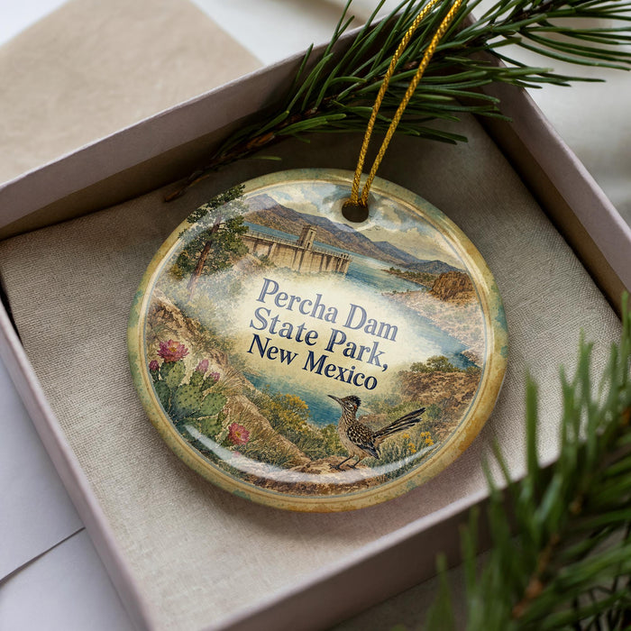 A decorative ornament with a bird and a scenic landscape, featuring the text "Percha Dam State Park, New Mexico".
