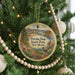 A round ornament hanging on a Christmas tree, featuring a scenic image of Percha Dam State Park, New Mexico.