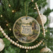 A round ornament hanging on a Christmas tree, featuring a scenic image of Pine Grove Furnace State Park, Pennsylvania.