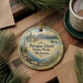 A decorative ornament with a scenic landscape of Pirogue Island, State Park, Montana, featuring a lake, mountains, and pine trees.