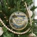 A round ornament hanging on a Christmas tree, featuring a scenic landscape of Pirogue Island, State Park, Montana.