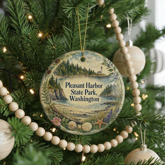 A round ornament hanging on a Christmas tree, featuring a scenic landscape with a lighthouse and a body of water.