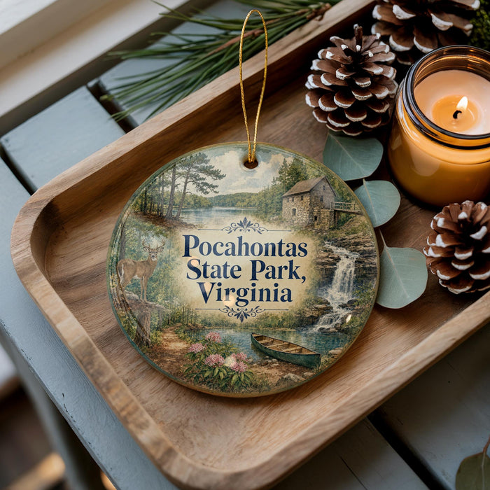 A decorative ornament featuring a scenic image of Pocahontas State Park, Virginia, with pine cones, a candle, and greenery surrounding it.