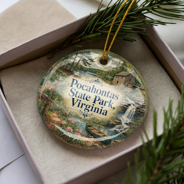 A decorative ornament with a scenic image of Pocahontas State Park, Virginia, displayed in a box with pine branches.