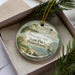 A round ornament with a lighthouse and a scenic landscape, featuring the text "Presque Isle State Park, Pennsylvania".