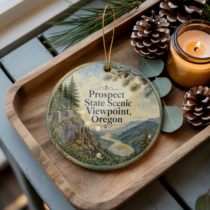 A wooden tray with a decorative ornament featuring a scenic mountain landscape, pine cones, and a lit candle.