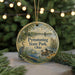 A circular ornament with a painting of a pond and birds, surrounded by greenery and a string of lights.
