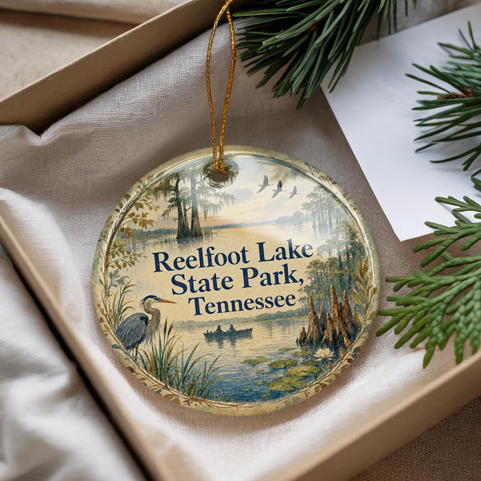A decorative ornament with a scenic image of Reelfoot Lake State Park, Tennessee, hanging from a string.