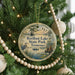 A round ornament hanging on a Christmas tree, featuring a scenic image of Reelfoot Lake State Park, Tennessee.