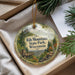 A decorative ornament with a scenic image of Rib Mountain State Park, Wisconsin, hanging from a string.