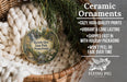Ceramic ornaments, featuring a nature scene with a waterfall and pine trees, are displayed in a basket.