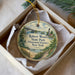 A decorative ornament in a box, featuring a scenic landscape with a lighthouse, bridge, and trees, along with the text "Robert Moses State Park (Thousand Islands), New York".
