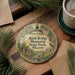 A decorative ornament with a scenic illustration of Rock Bridge Memorial Park, Missouri, featuring a bird perched on a tree branch and a small cabin in the background.