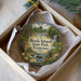 A decorative ornament in a box, featuring a scenic landscape with a waterfall and a house, with the text "Rock Island State Park, Tennessee" prominently displayed.