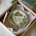 A decorative ornament in a box, featuring a scenic image of Rock Island State Park in Wisconsin.