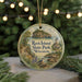 A round ornament with a scenic image of Rock Island State Park in Wisconsin, featuring a lighthouse, trees, and a bird.