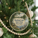A round ornament hanging on a Christmas tree, featuring a scenic image of Rockland Lake State Park in New York.