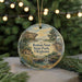 A round ornament with a painting of a scenic landscape, featuring a house, trees, and a waterfall, hanging from a string.