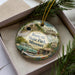 A decorative ornament featuring a vintage car and a scenic landscape, with the text "Route 66 State Park, Missouri" prominently displayed.