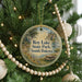 A round ornament hanging on a Christmas tree, featuring a scenic image of Roy Lake State Park in South Dakota.