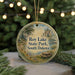 A round ornament with a scenic image of Roy Lake State Park, South Dakota, hanging from a string.