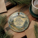 A decorative ornament with a mountain landscape and pine trees, featuring the text "Saddle Mountain State Natural Area, Oregon".