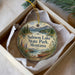 A decorative ornament in a box, featuring a scenic landscape with mountains, a lake, and a canoe, along with the text "Salmon Lake State Park, Montana".