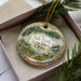 A decorative ornament with a scenic landscape of Salt Fork State Park, Ohio, featuring a deer and a waterfall.