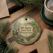 A round ornament with a scenic image of Salt Springs State Park, Pennsylvania, hanging on a wooden surface.