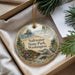 A decorative ornament with a scenic landscape of Saltwater State Park, Washington, featuring a bird, pine trees, and a body of water.