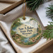A decorative ornament with a scenic landscape of Sam A. Baker State Park, Missouri, featuring a waterfall, pine trees, and a cabin.