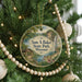 A Christmas tree decorated with ornaments, including a circular ornament with a scenic image of Sam A. Baker State Park, Missouri.