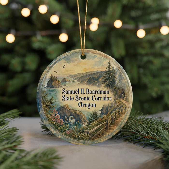 A round ornament with a scenic landscape depicting a mountain range, river, and forest, hanging from a string.