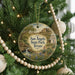 A round ornament hanging on a Christmas tree, featuring a scenic landscape of San Angelo State Park, Texas.