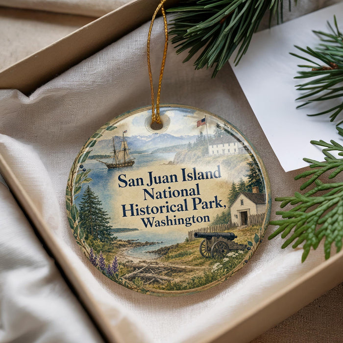 A decorative ornament with a scenic image of San Juan Island National Historical Park, Washington, featuring a ship, a lighthouse, and a cabin.