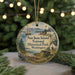 A round ornament with a painting of San Juan Island National Historical Park, Washington, featuring a ship, a cabin, and a landscape with mountains in the background.
