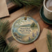 A decorative ornament featuring a scenic landscape of Sand State Park in Vermont, with pine trees and a lake in the background.