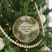 A round ornament hanging on a Christmas tree, featuring a scenic image of the Scio Trail at State Park, Ohio.