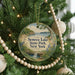 A round ornament hanging on a Christmas tree, featuring a scenic image of Seneca Lake State Park, New York.