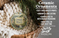 Ceramic ornaments, featuring a Sequoyah State Park, Oklahoma ornament hanging in a basket with pine branches.