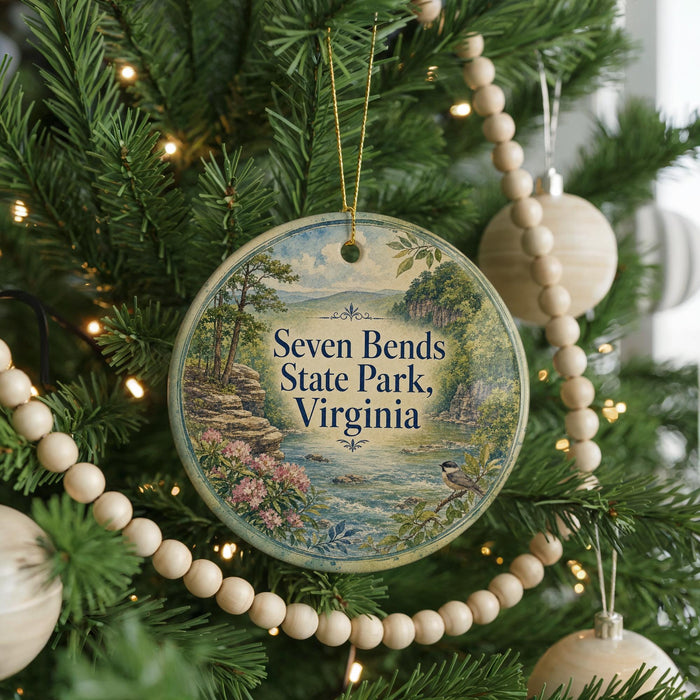 A round ornament on a Christmas tree, featuring a scenic landscape with a river and mountains, with the text "Seven Bends State Park, Virginia" displayed on it.
