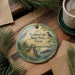 A round ornament with a scenic illustration of Sheldon Lake State Park, Texas, featuring a bird, a bridge, and a body of water.